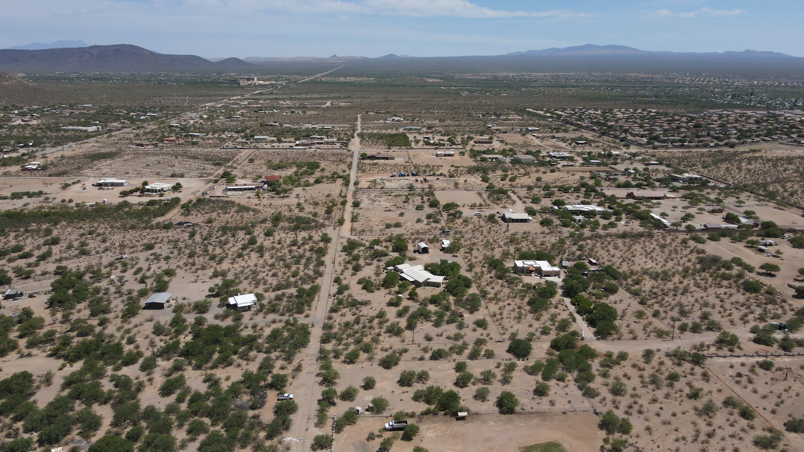 Wide view of open desert parcels divided by dirt roads
