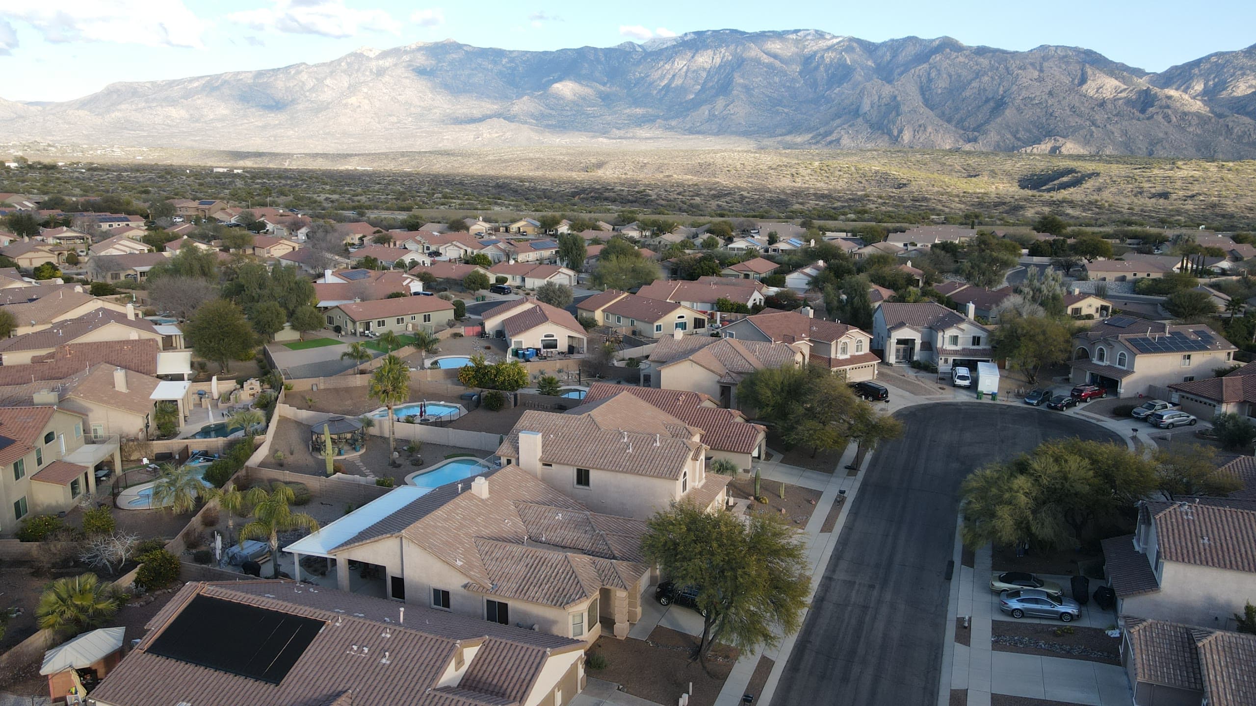 New neighborhood streets and pools below the Catalinas