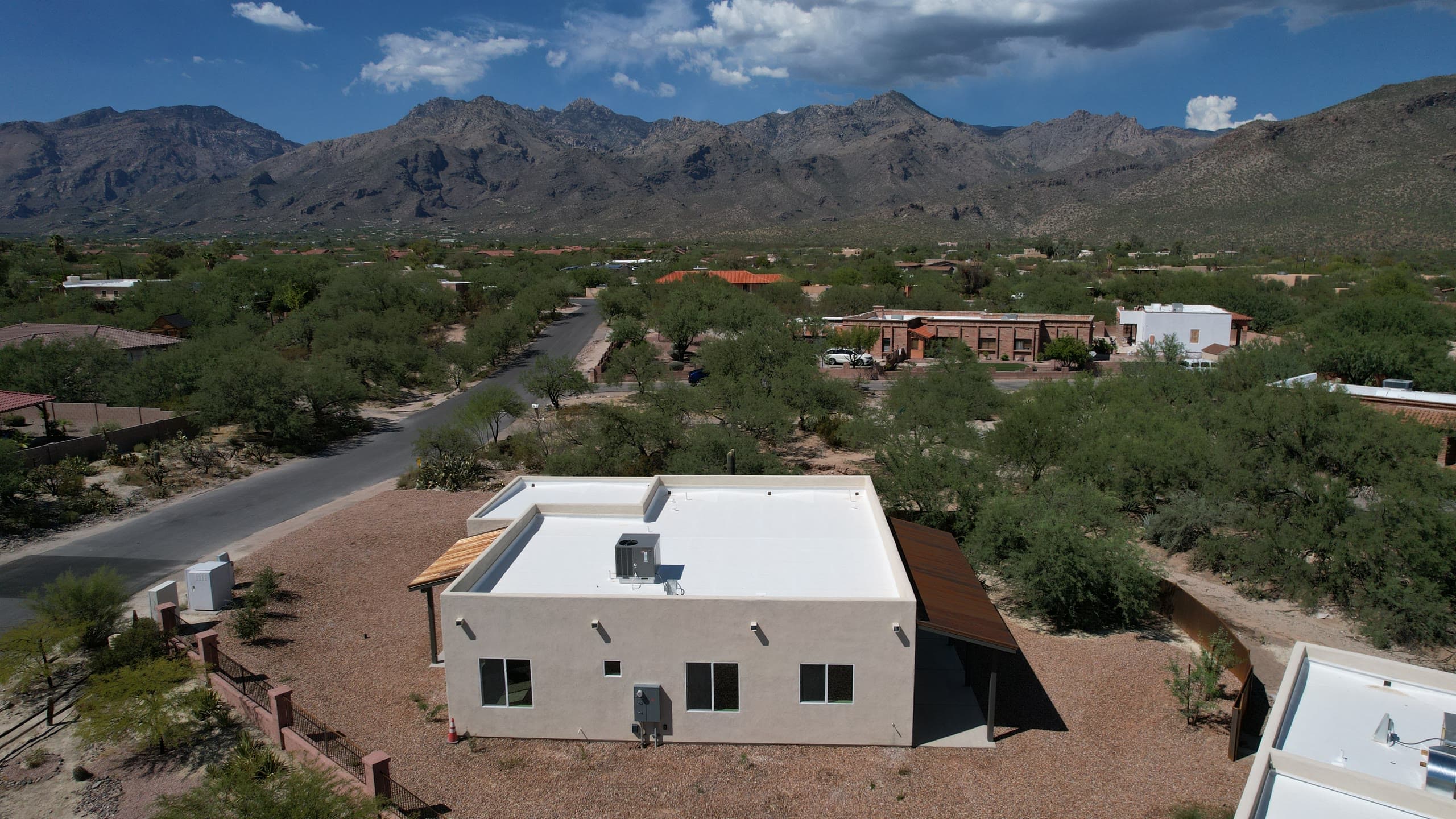 White stucco home below the Santa Catalina Mountains